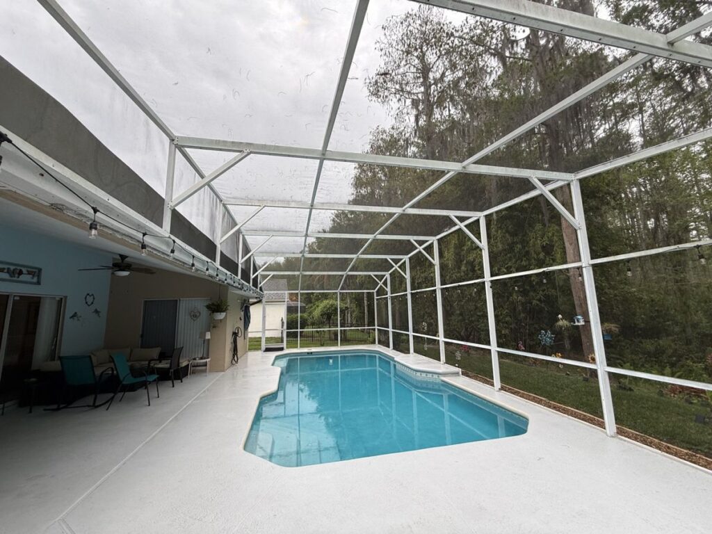 White aluminum pool cage before restoration in East Orlando, FL