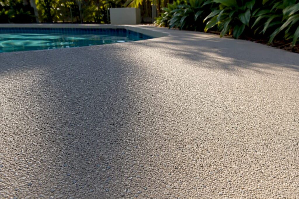 Textured pool deck coating with traction additive