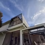 Pool cage roof meeting a second-floor balcony after restoration in Windermere, FL