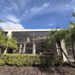 Long side of a dark bronze pool enclosure with new screens and landscaping in Windermere, FL