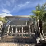 Front view of a restored pool cage with new screens and the pool inside in Windermere, FL