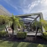 Dark bronze pool cage with all-new screens along a lakefront yard in Windermere, FL